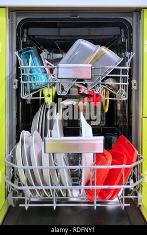 Front view of fully loaded dishwasher with washed clean dishes. Stock Photo