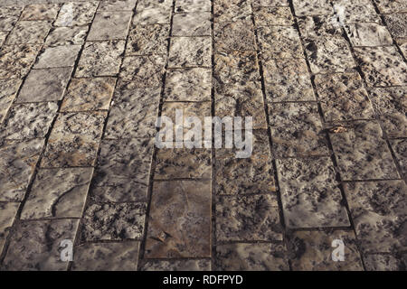 Ancient stone pavement texture. Granite cobblestoned pavement background. Stock Photo