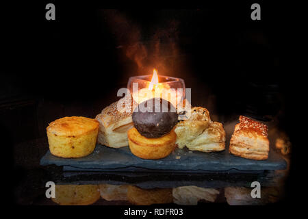Many types of bread rolls with candle on elegant black granite table top Stock Photo