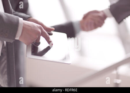 close up.businessman using digital tablet on background of hand Stock Photo