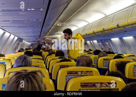 Pre-flight safety demonstration. Interior of Ryanair flight from ...