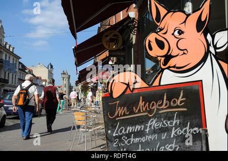18.09.2014, Potsdam, Brandenburg, Germany, Europe - Pedestrians are walking by a butcher shop in the Dutch Quarter. Stock Photo