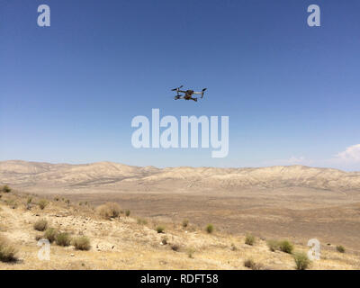 DJI Mavic Pro drone hovering over desert landscape ( camera drone ) - California USA Stock Photo