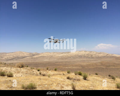 DJI Mavic Pro drone hovering over desert landscape ( camera drone ) - California USA Stock Photo