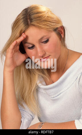 contemplative young blonde woman Stock Photo
