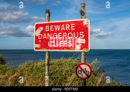 Sign: Beware dangerous cliffs, seen in Hartley, Northumberland, England ...