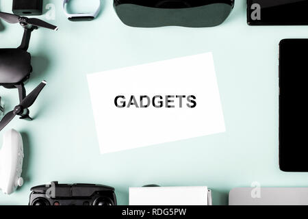 Different modern devices on a blue background with an inscription in the center of gadgets Stock Photo