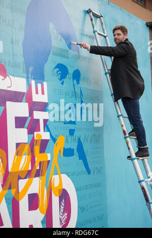 Glasgow, UK - 14th January 2019.  Minister for Europe, Migration and International Development Ben Macpherson unveils a new mural created by Scottish  Stock Photo