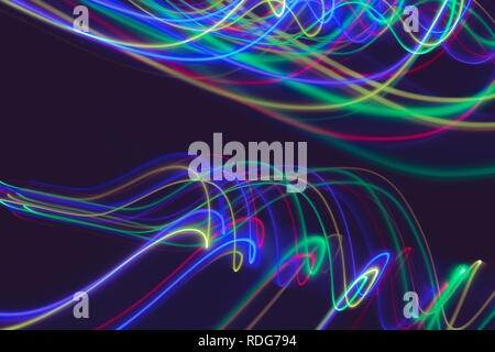 Abstract light lines on black background. Light painting photography. Abstract design with lights in the dark. Stock Photo