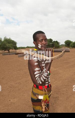 Karo warrior with body and facial paintings holding a rifle, Omo river valley, Southern Ethiopia, Africa Stock Photo