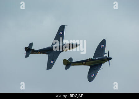 Hawker Sea Hawk and Supermarine Seafire flying in formation at an airshow. Royal Navy Fleet Air Arm aircraft fighter planes. Early vintage jet Stock Photo