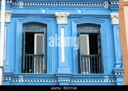 Colourful blue painted house in Chinatown Singapore, one of the many older style traditional buildings in the city, attracting tourists and visitors. Stock Photo