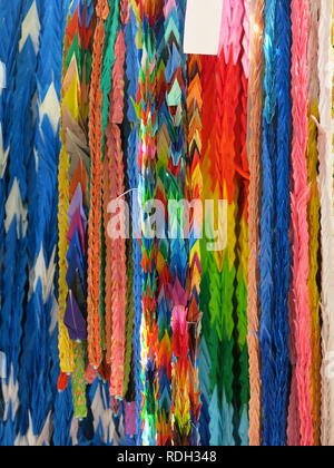 Strings of multi-coloured folded paper cranes are hung to remember the children in the nuclear attack at Hiroshima, especially Sadako Sasaki. Stock Photo