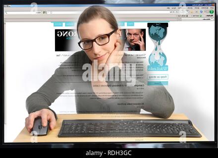 Woman surfing the internet on a computer, on the WikiLeaks web page, view from the monitor Stock Photo