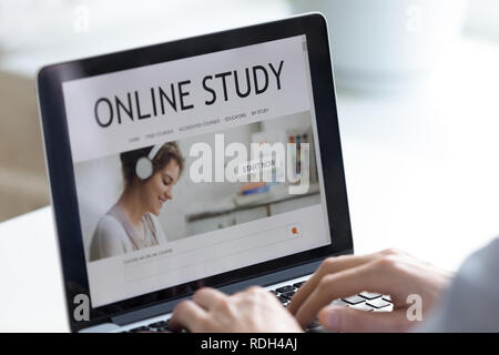 Close up man using laptop, browsing distance learning website Stock Photo