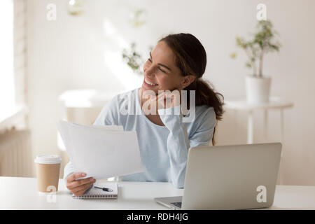 Smiling businesswoman with documents thinking about business str Stock Photo