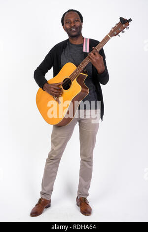 Full body shot of handsome African man playing the guitar Stock Photo