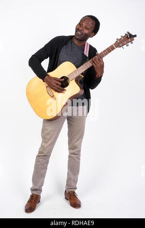 Full body shot of handsome African man playing the guitar Stock Photo