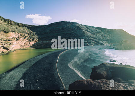 Sunset landscape of Charco de los Clicos (Green Lagoon) Lago Verde near El Golfo in Yaiza, Las palmas, Lanzarote, Spain Stock Photo