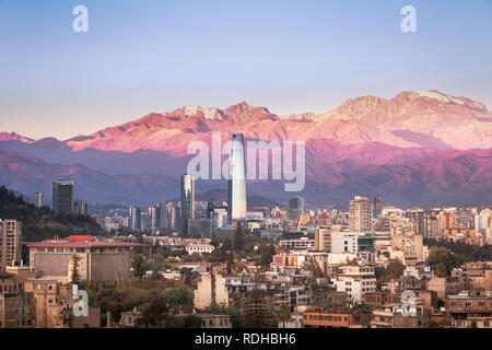 Aaerial view of Santiago skyline at sunset with Costanera skyscraper and Andes Mountains - Santiago, Chile Stock Photo