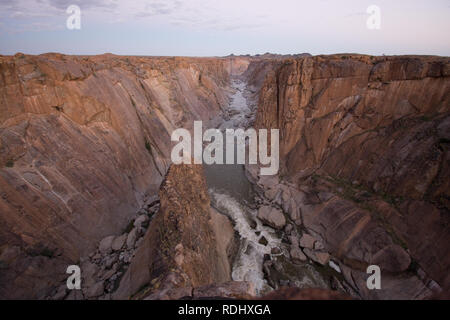 Arrow Point offers a dramatic and exposed viewpoint for brave hikers to overlook the Orange River in Augrabies Falls National Park, South Africa. Stock Photo