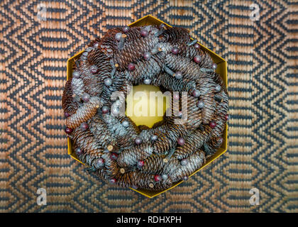 Designer made Christmas wreath, Composition made of Spruce cones, sprayed with silver shiny spray paint and decorated with various holiday decorations Stock Photo