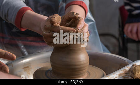 Teaching pottery to children. The teacher gives a master class in modeling Stock Photo