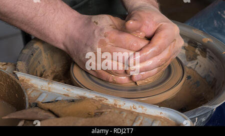 Teaching pottery to children. The teacher gives a master class in modeling Stock Photo