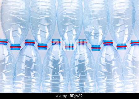 Stack of empty plastic water bottles waste on white background Stock Photo