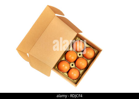 A photo of eggs in a craft carton, isolated on a white background with a clipping path Stock Photo