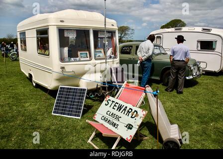 The classic caravan steward with a 1970 WAK caravan and Rover 100 car at the Anglesey Vintage Rally, Anglesey, North Wales, UK, May 2010 Stock Photo