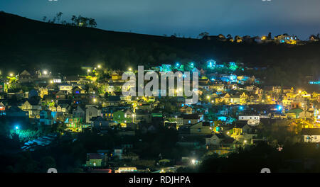 Night scene in the valley with bright houses with colorful lights makes the night scene in the countryside more vibrant in the Da Lat plateau, Vietnam Stock Photo