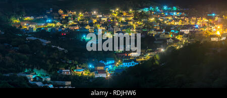 Night scene in the valley with bright houses with colorful lights makes the night scene in the countryside more vibrant in the Da Lat plateau, Vietnam Stock Photo