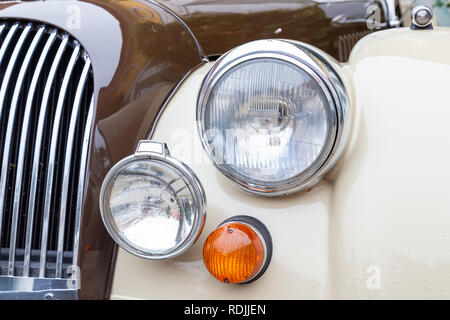 Headlamp, turn signal and grille of a British sports car of the seventies Stock Photo