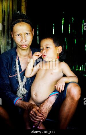 Luang Namta / Laos - JUL 06 2011: lanten tribal member woman with her kid from the northern part of the country with silver necklace Stock Photo