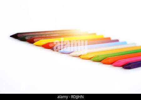 Colored wax crayons in row. Isolated on the white background. Stock Photo