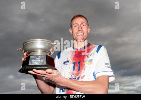 Scotland captain Grant Irvine with the Quaich trophy after the Marine Harvest Scotland v Ireland shinty hurling international, played in Inverness. Stock Photo