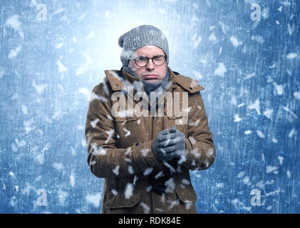 Handsome young boy shivering and trembling at snowstorm concept  Stock Photo