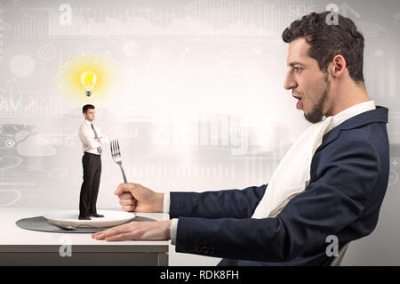 Giant businessman eating small man with financial background  Stock Photo