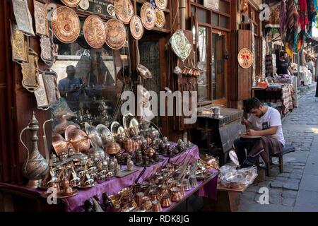 Gaziantep, Turkey - September 11, 2018: The copper master works in front of his store in the bakircilar (coppersmiths) bazaar of Gaziantep on Septembe Stock Photo