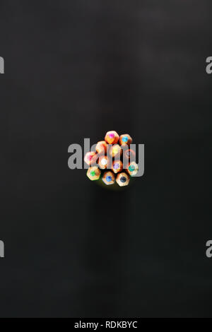 Top view of many colored pencil. Isolated on the black background. Stock Photo