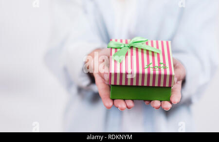 beautiful girl holding a present for christmas and new year Stock Photo