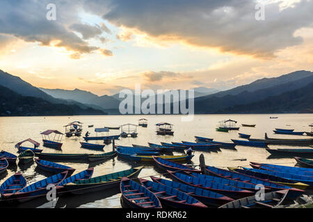 Colorful wooden boats in Phewa Lake at sunset, Pokhara, Nepal Stock Photo