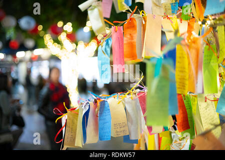 Wishes written on Tanzaku, small pieces of paper, and hung on a Japanese wishing tree, located in the Little Tokyo section of Los Angeles, California Stock Photo