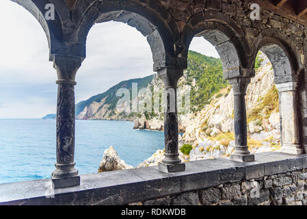 View through columns of Church of St. Peter in Portovenere or Porto Venere town on Ligurian coast. Province of La Spezia. Italy Stock Photo
