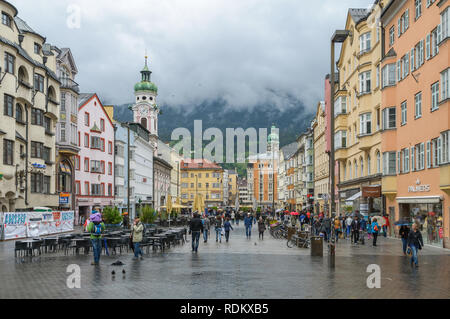 INNSBRUCK, AUSTRIA - MAY 11, 2013: The famous Maria Theresien Strass in the old city center of Innsbruck, Austria on May 11, 2013.  It is a rainy day  Stock Photo