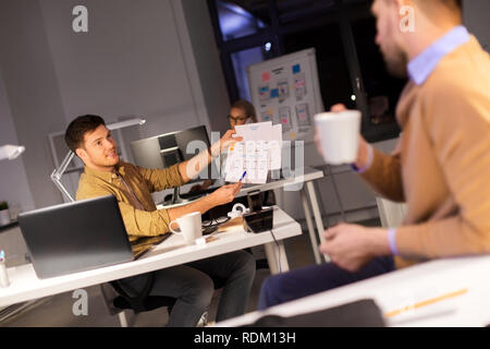 designers or software developers at night office Stock Photo