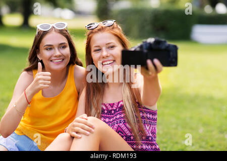 teenage bloggers recording video by camera in park Stock Photo