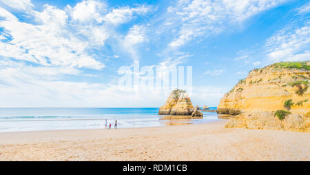 family at deserted beach in pre-season Stock Photo