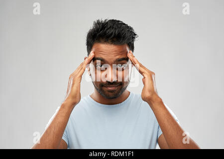 indian man touching his temples Stock Photo